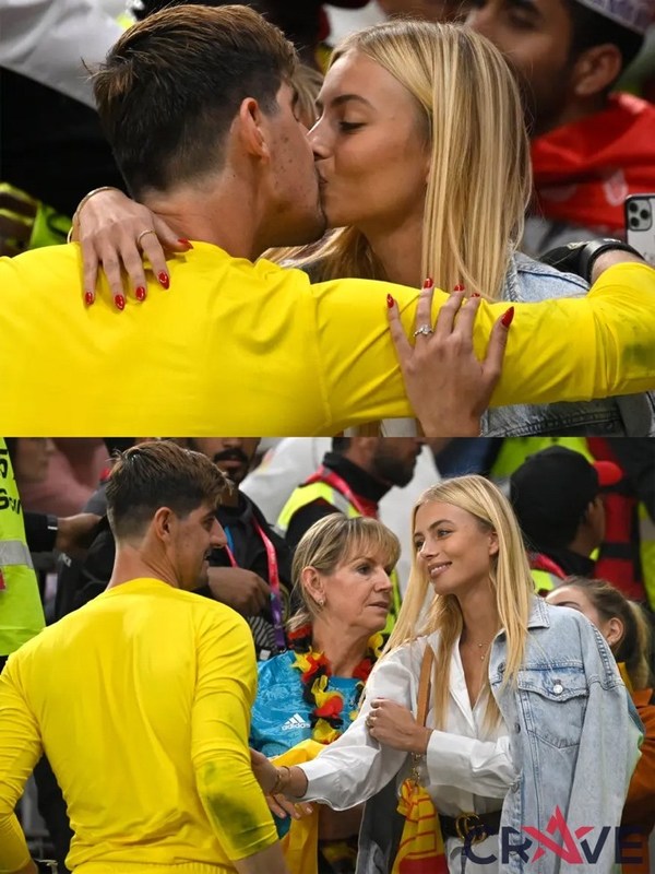图为库尔图瓦在小组赛首战告捷后与看台上的未婚妻拥吻